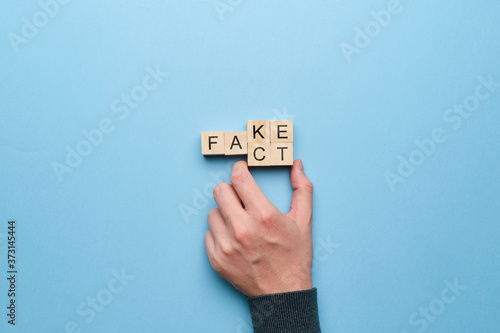Obraz na plátne Concept of fact and fakes on wooden cubes