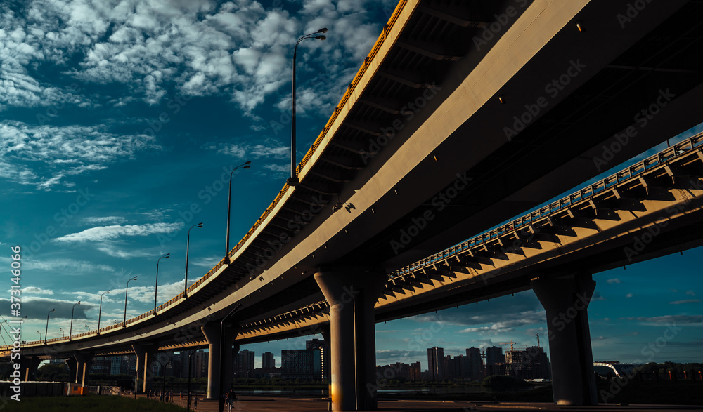Highway overpass in Kazan, Russia, under view of the concrete pillars. The concept of urbanization. Highway overpass in Kazan, Russia, under view of the concrete pillars. The concept of urbanization.