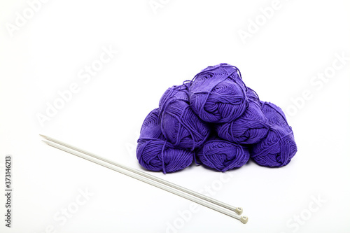 Balls of blue knitting wool and needles isolated on a white background photo