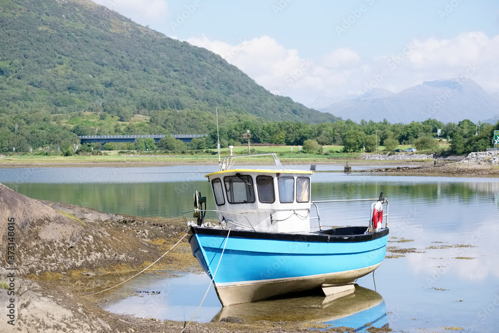 Blue boat in sea water for tranquility calm peace and mindfulness in Argyll and Bute
