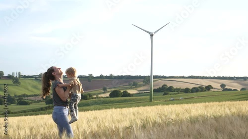 Happy family, mother and son laughing and playing together outdoors at sunset