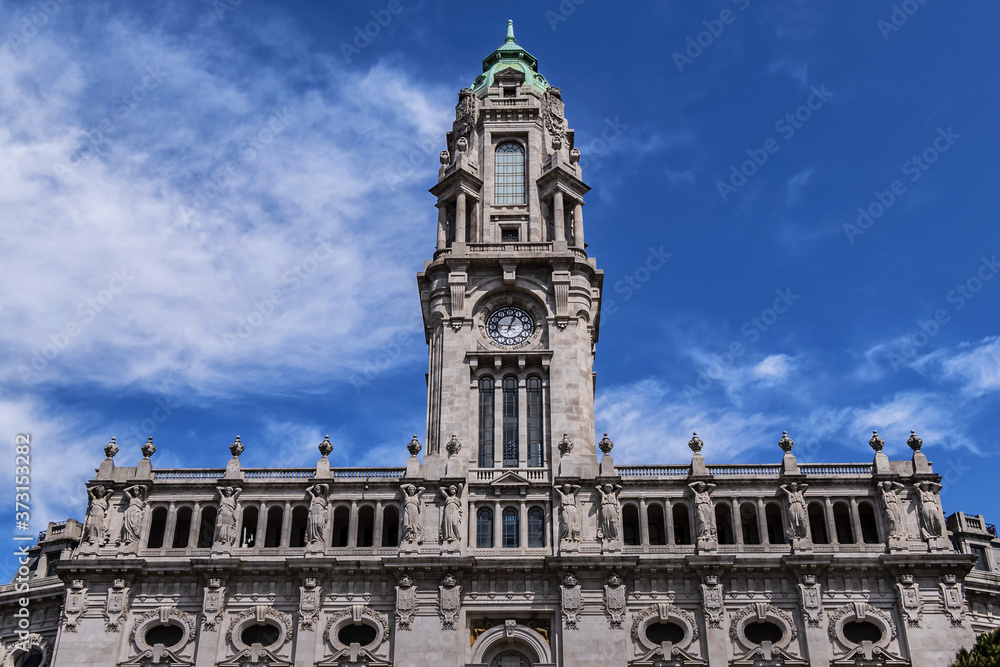 View of 70m high tower with a carillon clock at City Hall building (Camara Municipal do Porto). City Hall - a Neoclassic building at Avenida dos Aliados in Porto, Portugal.