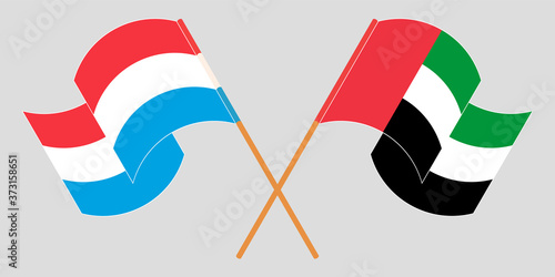 Crossed and waving flags of Luxembourg and the United Arab Emirates