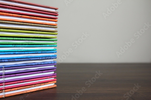 Education - books in colored covers stacked in a pile  colors of the rainbow
