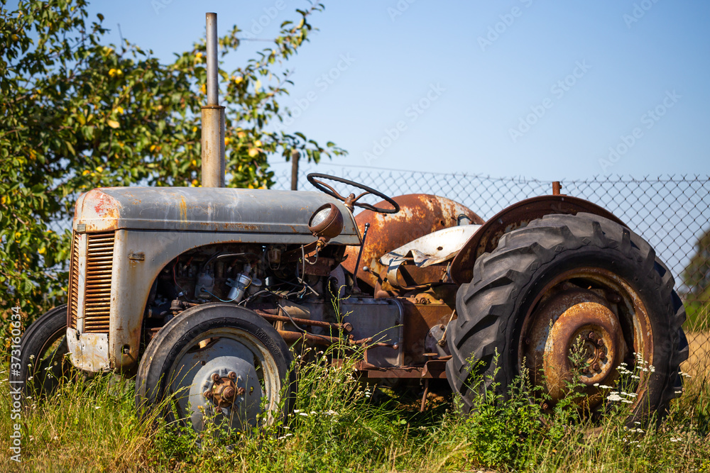 Obraz premium Old tractor standing on the field
