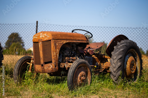 Old tractor standing on the field