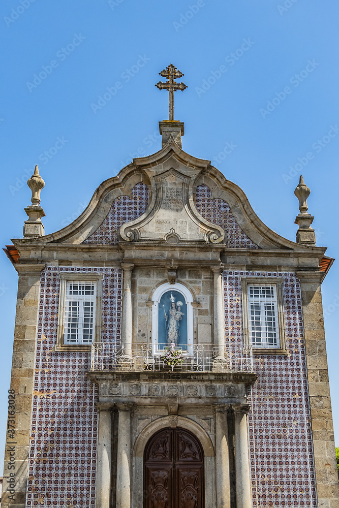 Chapel of Our Lady of White (Capela de Nossa Senhora a Branca) in Braga. Main portal with Tuscan columns, a decorated frieze and image of patron saint with date of 1771, at top. Braga, Portugal.