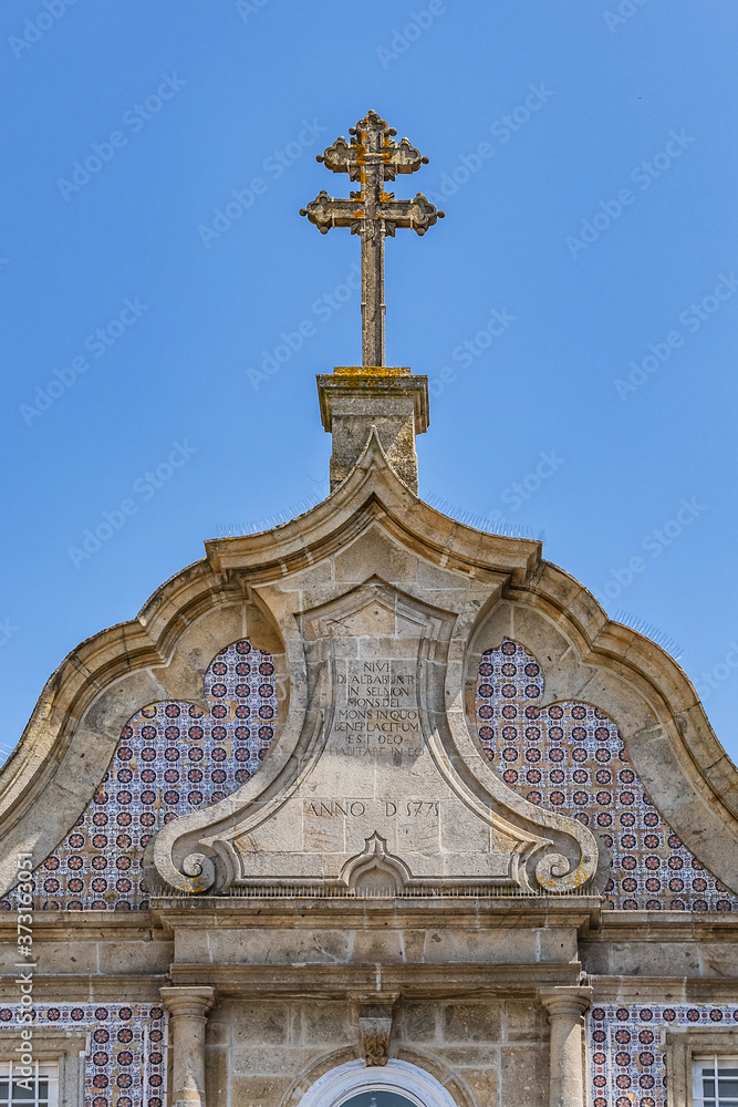 Chapel of Our Lady of White (Capela de Nossa Senhora a Branca) in Braga. Main portal with Tuscan columns, a decorated frieze and image of patron saint with date of 1771, at top. Braga, Portugal. Chapel of Our Lady of White (Capela de Nossa Senhora a Branca) in Braga. Main portal with Tuscan columns, a decorated frieze and image of patron saint with date of 1771, at top. Braga, Portugal.