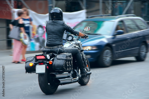 Stylish girl in black leather clothes driving on motorcycle © alexmak