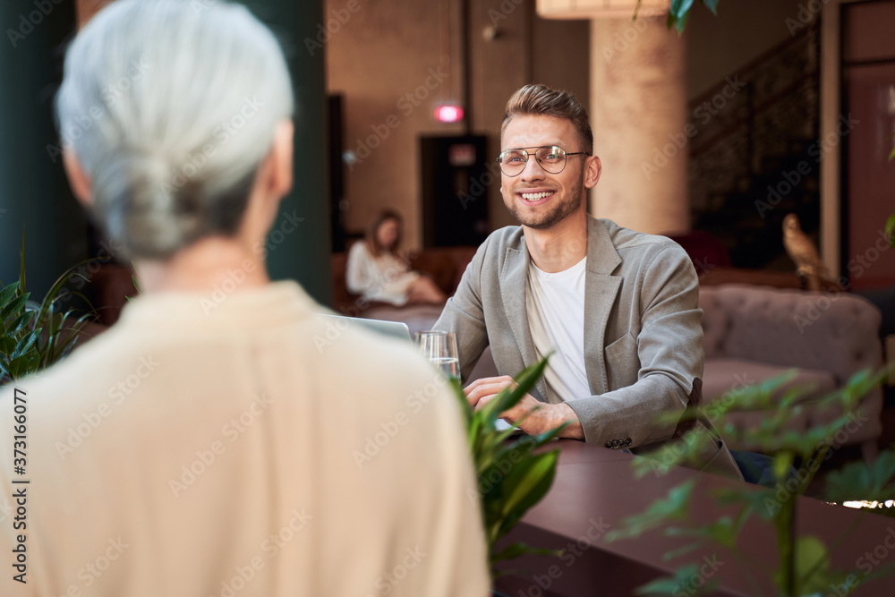 Mirthful man making order at the bar counter Mirthful man making order at the bar counter