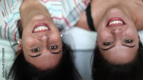 Two female friends upside down. Best girlfriends laughing and smiling