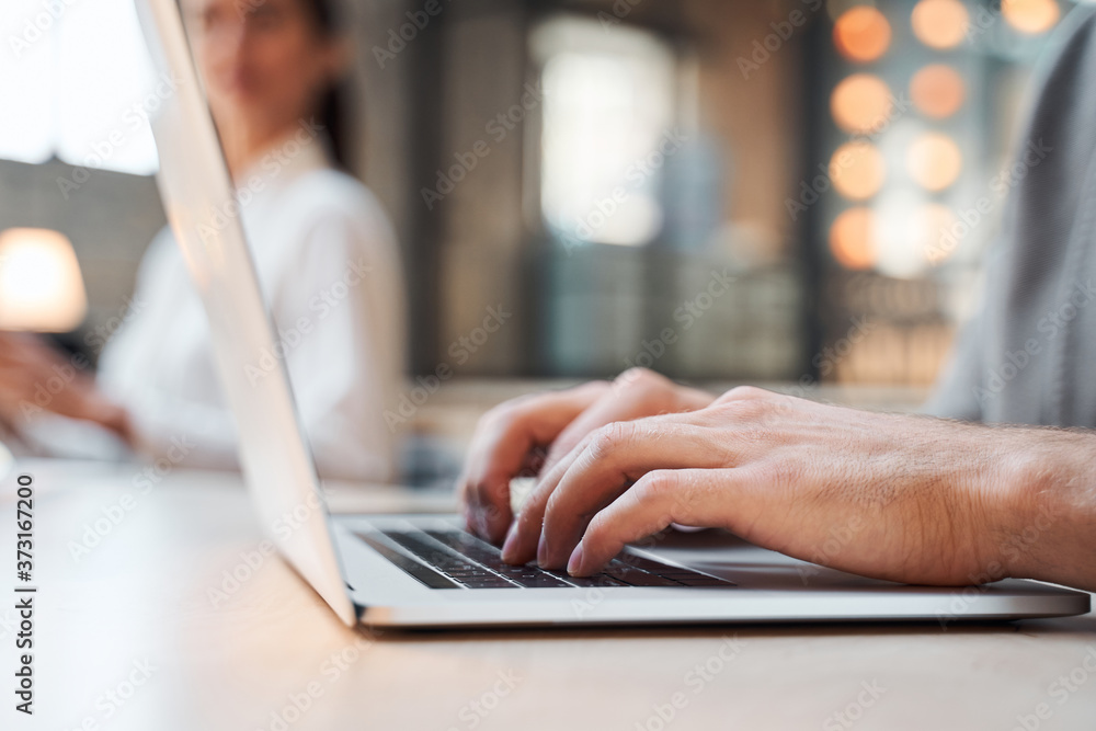 Male hands texting on the modern device in workplace Male hands texting on the modern device in workplace