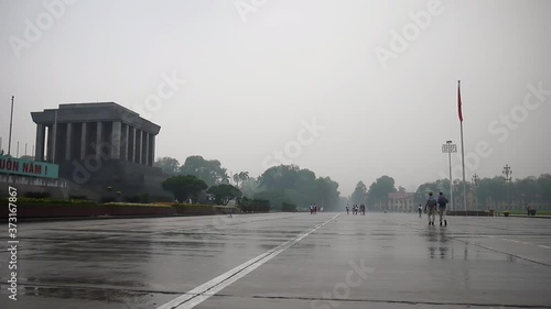 Ho Chi Minh mausoleum in the rain with the Vietnamese flag