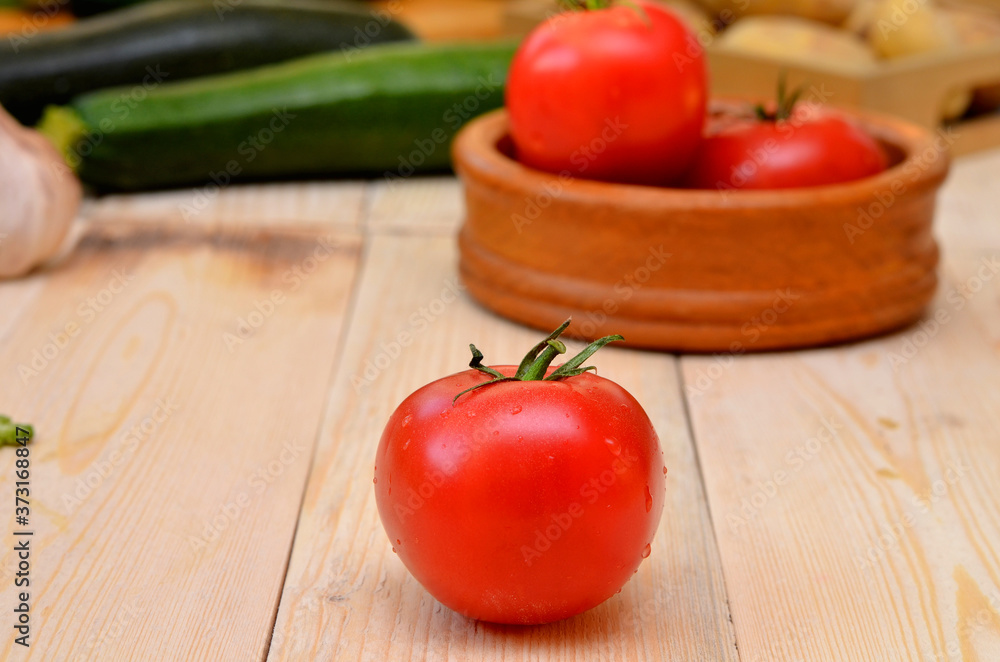 still life with vegetables ripe red tomato on a wooden table still life with vegetables ripe red tomato on a wooden table