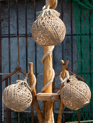 Vertical shot of lantern covers made of abaca ropes photo