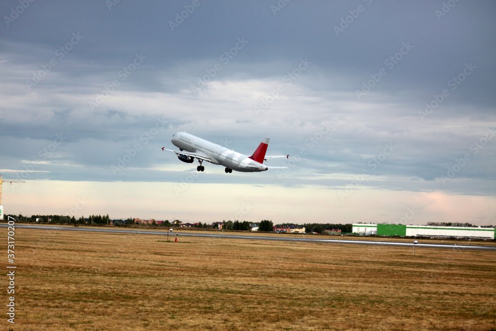 Passenger plane takes off from the airport runway. Side-view of aircraft Passenger plane takes off from the airport runway. Side-view of aircraft