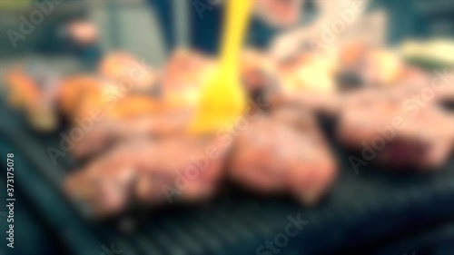 Blurred background. Big beautiful cuts of meat grilled on the barbecue photo