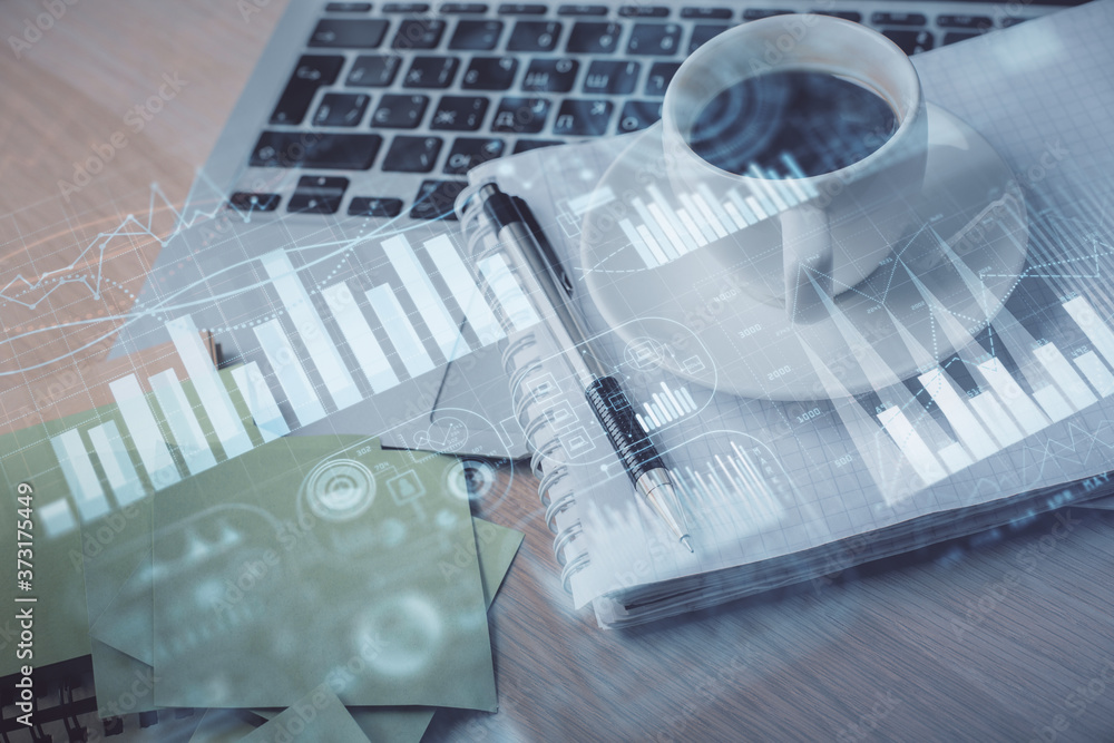 Double exposure of forex chart drawing and desktop with coffee and items on table background. Concept of financial market trading Double exposure of forex chart drawing and desktop with coffee and items on table background. Concept of financial market trading