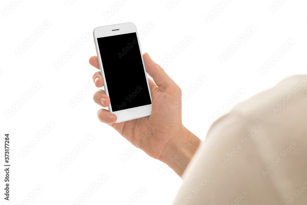 Man holding a smartphone with empty black screen. Mobile phone in a vertical position in hands and isolated on white background. Studio shot. Third person view. Camera shot from over shoulder. Man holding a smartphone with empty black screen. Mobile phone in a vertical position in hands and isolated on white background. Studio shot. Third person view. Camera shot from over shoulder.