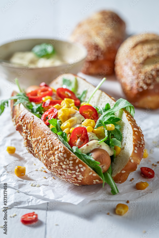 Homemade hot dogs with corn, chilli and sauce