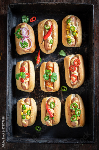 Tasty mini hot dogs with pork sausage and sauce