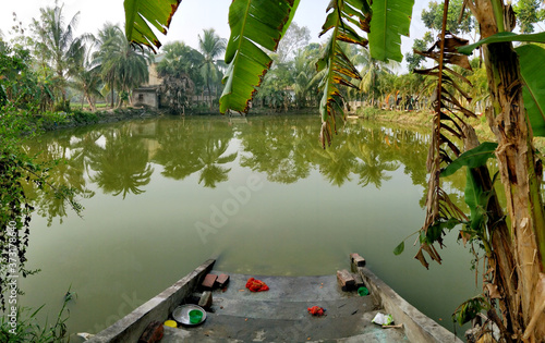 A pond (or 'Pukur' in Bengali) with steps leading to it at LokshIksha Bhawan in Joygopalpur in West Bengal- 9th Feb 2018 photo