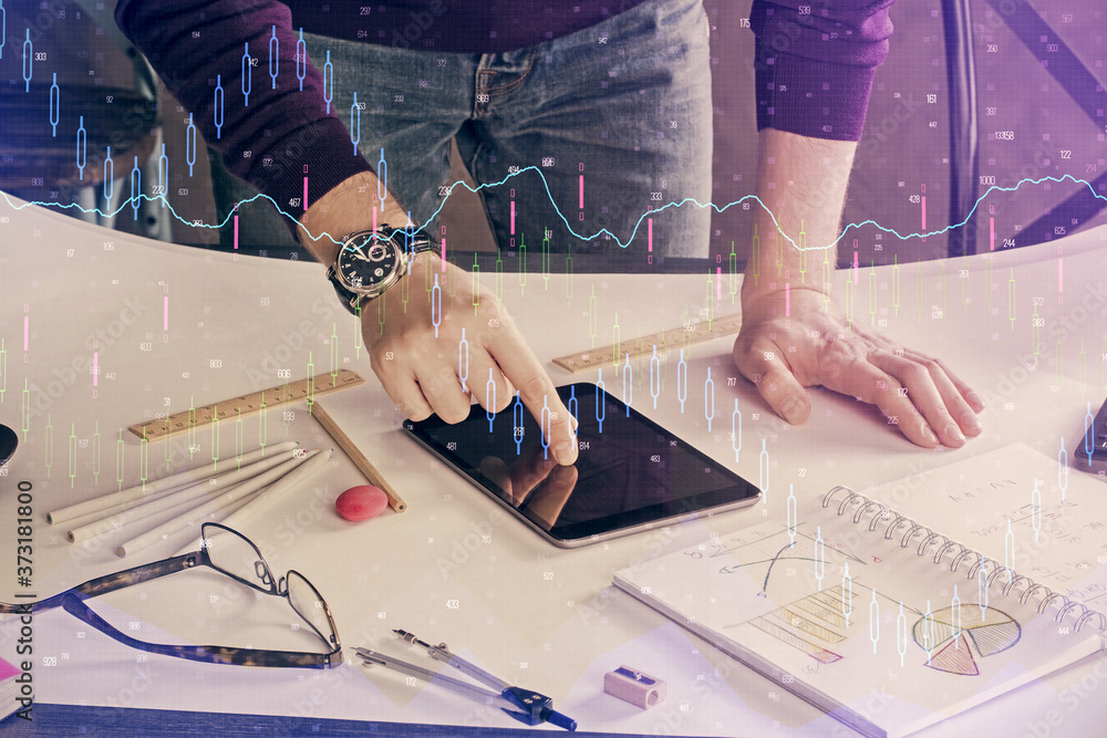 Double exposure of man's hands holding and using a digital device and forex graph drawing. Financial market concept. Double exposure of man's hands holding and using a digital device and forex graph drawing. Financial market concept.