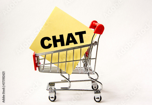 Shopping cart and text chat on white paper note list. Shopping list, business concept on white background.