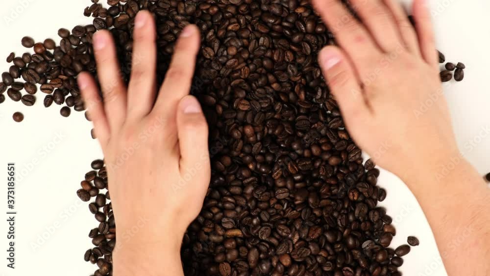 roasted brown coffee beans, female hands, top view roasted brown coffee beans, female hands, top view