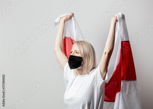 woman in face mask with national Belarus flag on white background photo