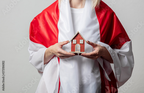 woman with national Belarus flag and  home symbol on white background photo