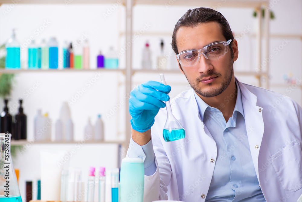 Young male chemist working in the lab Young male chemist working in the lab