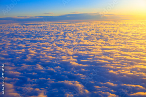 Dusk over the clouds . Flying over the endless cloudscape 
