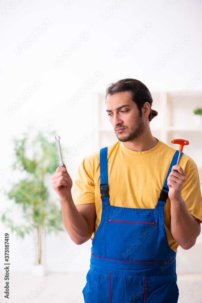 Young male carpenter working indoors Young male carpenter working indoors