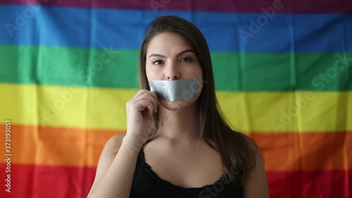 Woman taking off tape with over mouth, democracy LGBT freedom concept photo