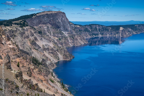 Beautiful cliffs along the shoreline of Crater Lake National Park in the summer