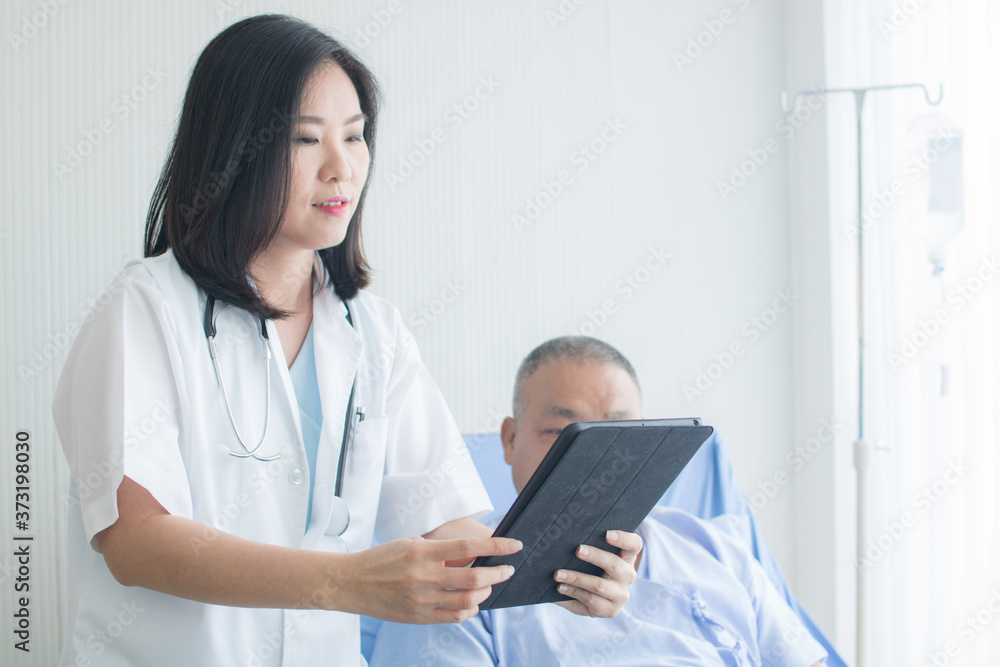 Asian doctor woman explain disease symptoms on tablet to old patient man Asian doctor woman explain disease symptoms on tablet to old patient man