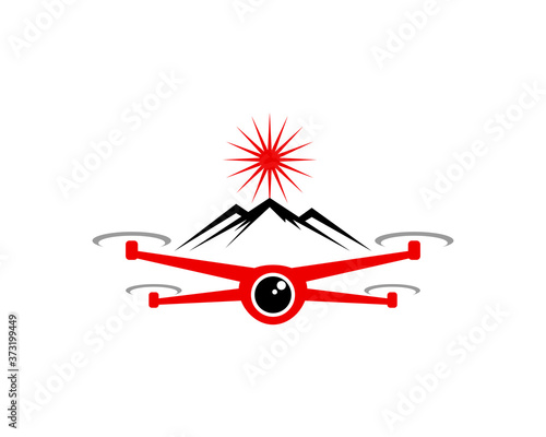 Flying red drone with mountain behind
