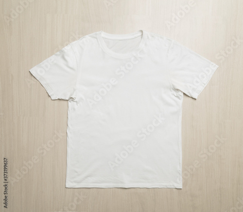 White T-shirts mockup template on wooden floor.