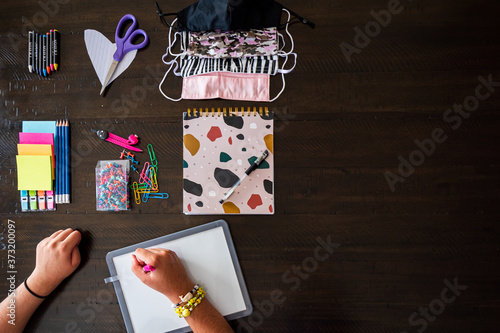Back to School, stationery items display pencils, pen, scissiors, face mask, colour, pins