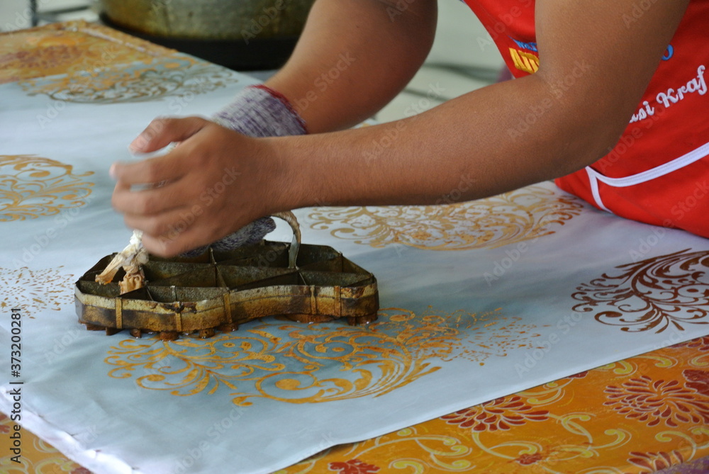 KUALA LUMPUR, MALAYSIA JUNE 25, 2016 Handmade stamping batik. An artist press get batik
