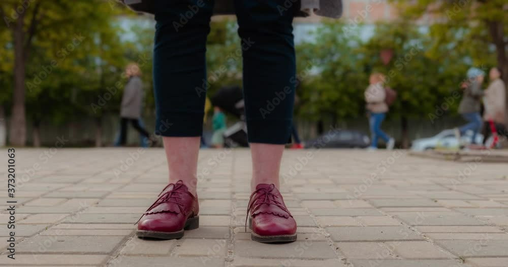 Time lapse of the feet of a girl which is standing in the middle of a green park. Time lapse of the feet of a girl which is standing in the middle of a green park.