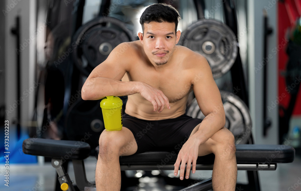 Sporty man training with dumbbell in gym, Bodybuilder sport fitness training Sporty man training with dumbbell in gym, Bodybuilder sport fitness training