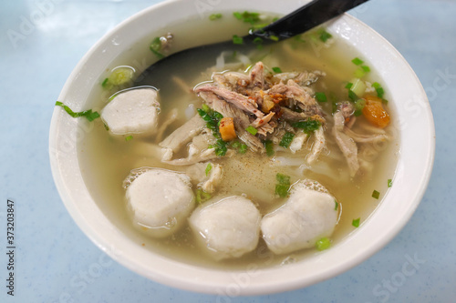 Penang hawker delight - Koay Teow Th’ng, Flat Rice Noodle served in a clear soup broth, topped with fish balls, duck meat, dressed in light Soy Sauce