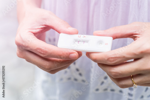 hand holding pregnancy tester