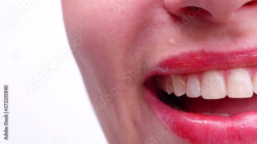 Middle aged woman laughs on white background showing perfect white teeth. Natural teeth, beautiful mouth, full sensual lips