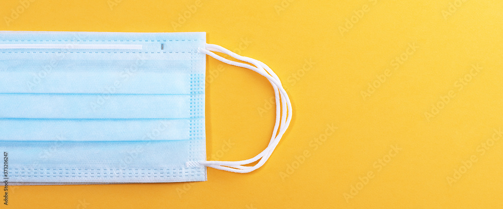 Medical mask protective virus, flu, disease. Isolated on a yellow background. Medical mask protective virus, flu, disease. Isolated on a yellow background.
