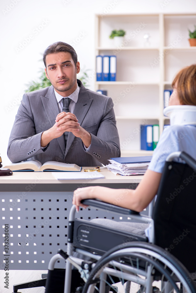 Young injured woman and male lawyer in the courtroom Young injured woman and male lawyer in the courtroom