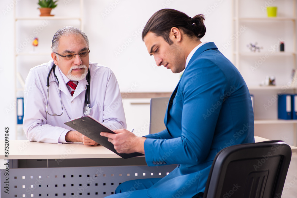 Young businessman meeting with old doctor Young businessman meeting with old doctor