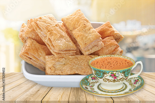 indian khari or kharee or salty Puff Pastry Snacks, with tea, Khari bread Rusk, Puff Pastry Snacks, fresh square shaped puff pastry biscuit snacks with puffed crispy golden brown crust layers khari photo